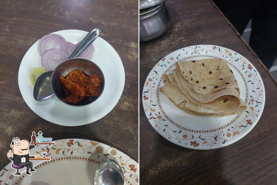 Take a seat at one of the tables at Hotel Shri Sarvana pure veg