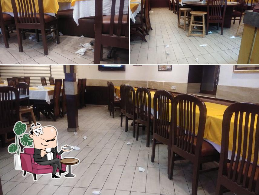 Take a seat at one of the tables at Bombay Bites (B-Square) Restaurant