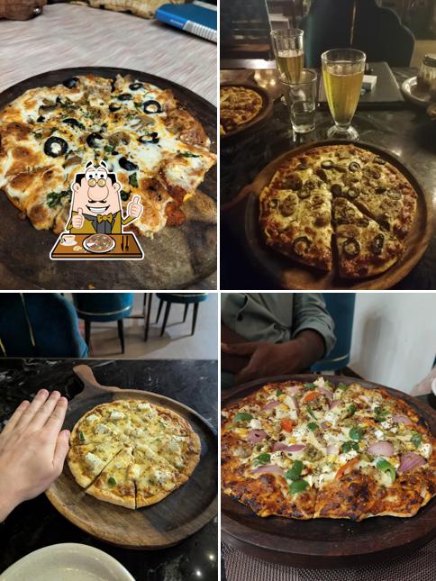 At The Atulyam Rooftop Restaurant, you can enjoy pizza