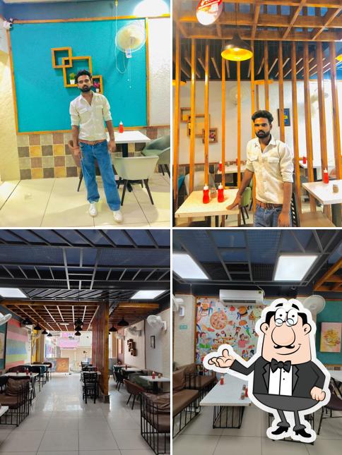 Take a seat at one of the tables at Hungry Point - Gadarpur