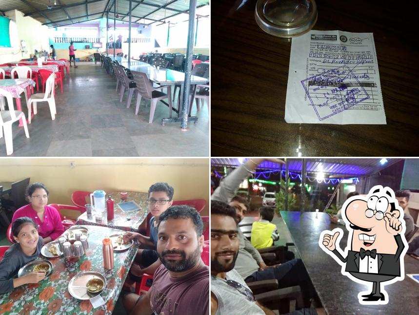 Take a seat at one of the tables at HOTEL KAVERI HIGHWAY PUNJABI DHABA