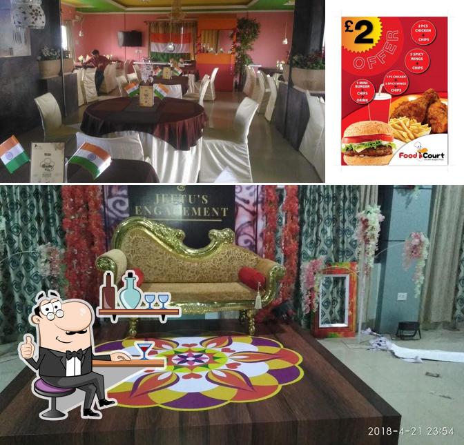 Take a look at the image showing interior and burger at Food Court