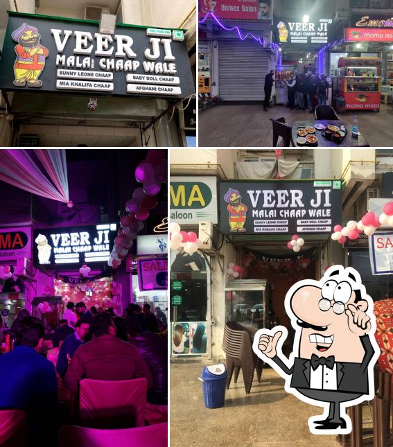 Take a seat at one of the tables at Veer Ji Malai Chaap Wale Vasundhra Sector 18