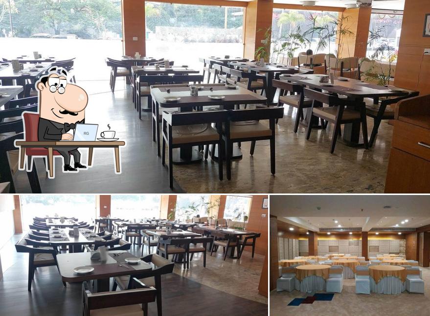 Take a seat at one of the tables at Midtown The Multi Cuisine Restaurant