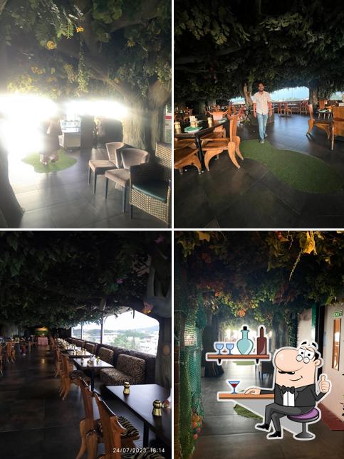 Take a seat at one of the tables at Gufha Restaurant, Hubli