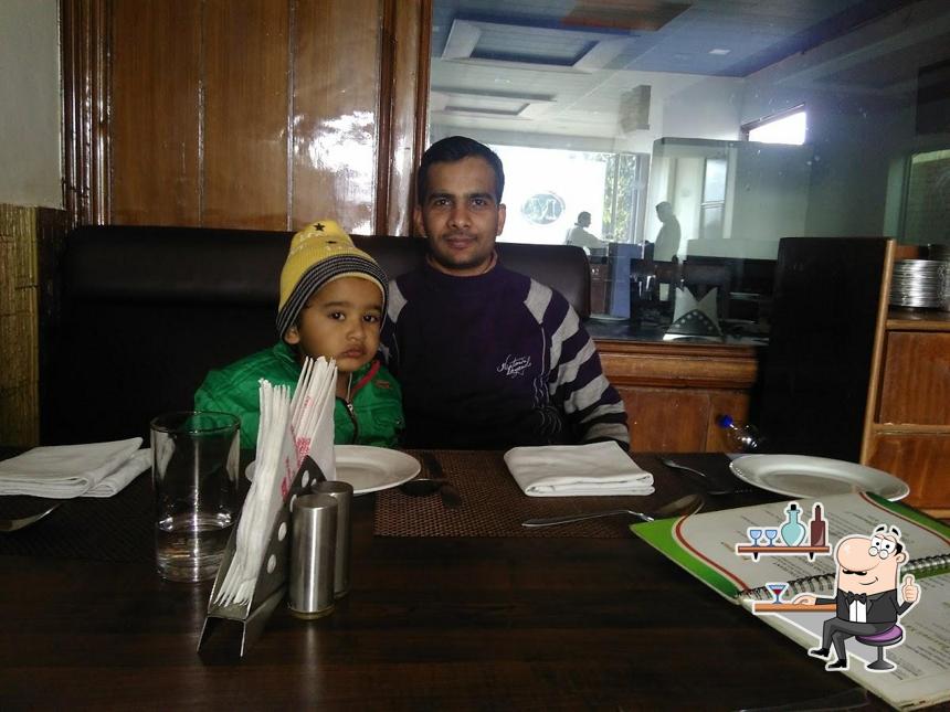 Take a seat at one of the tables at Jashan A/C Pan Shop