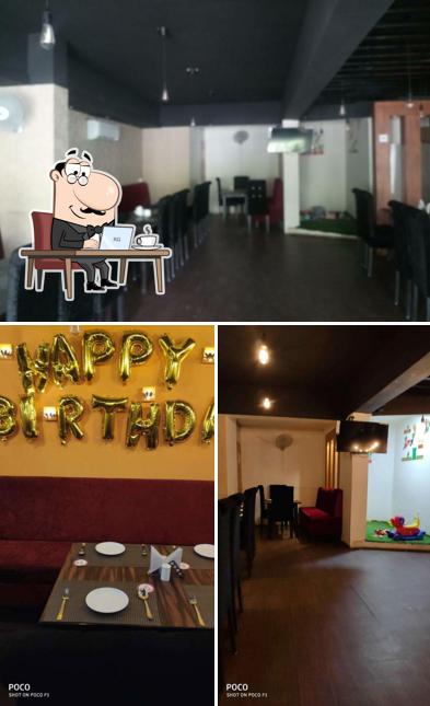 Check out the image showing interior and dining table at Daawat Cuisine