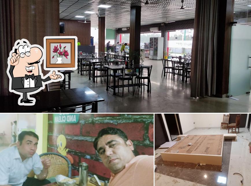 Take a seat at one of the tables at Vegहारी(VegHaari) - The Family Dhaba