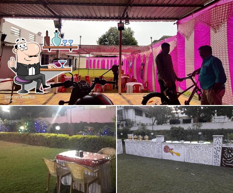 Take a seat at one of the tables at Nisarg Garden Restaurant