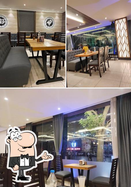 Take a seat at one of the tables at Bahuka Restaurant, AECS Layout