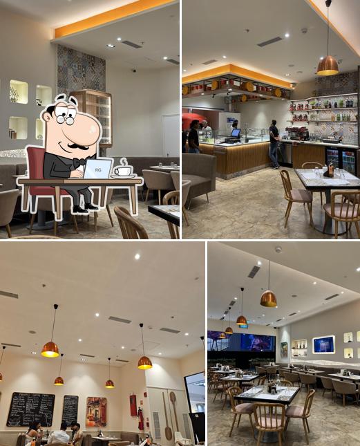 Take a seat at one of the tables at Si Nonna’s – The Original Sourdough Pizza, Phoenix Mall of the Millennium Wakad, Pune