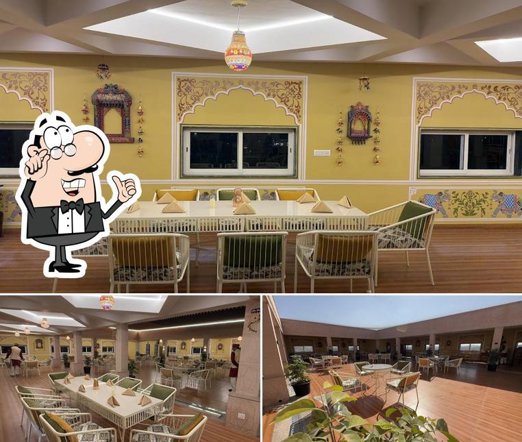 Take a seat at one of the tables at SHAHI VIRASAT , Neemrana