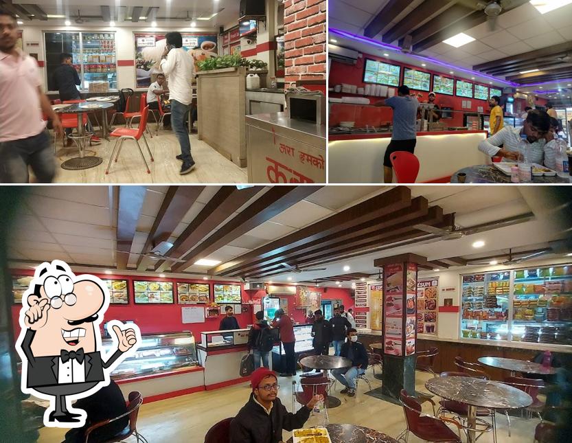 Take a seat at one of the tables at Comesum Food Plaza