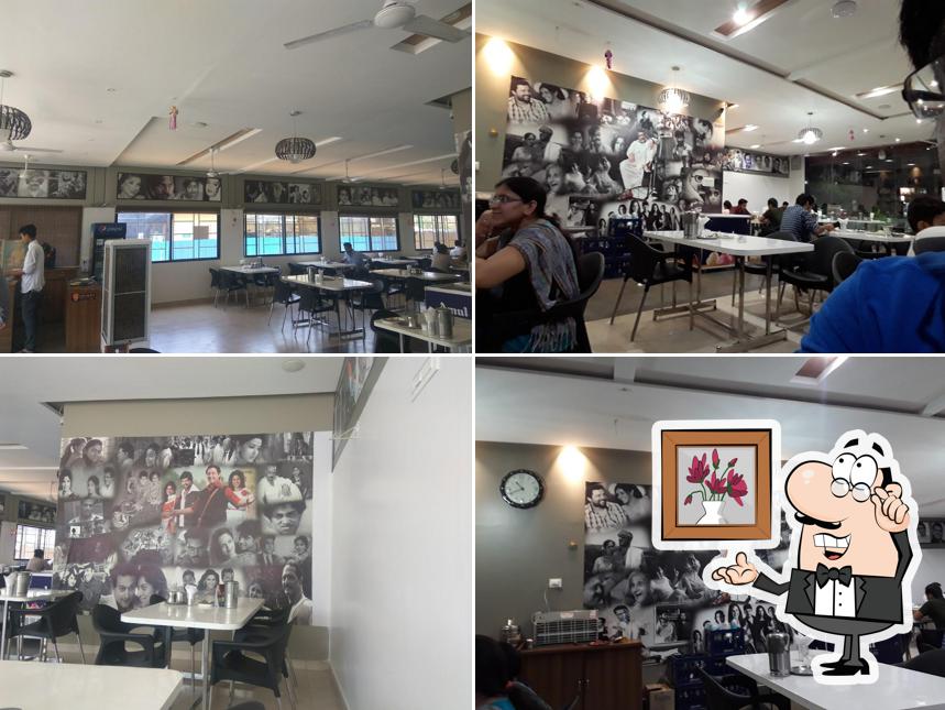 Take a seat at one of the tables at HOTEL MARATHI BANA PURE VEG