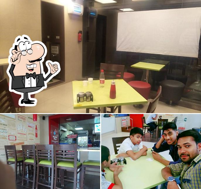 Take a seat at one of the tables at Domino's Pizza Ram Nagar, Dewas