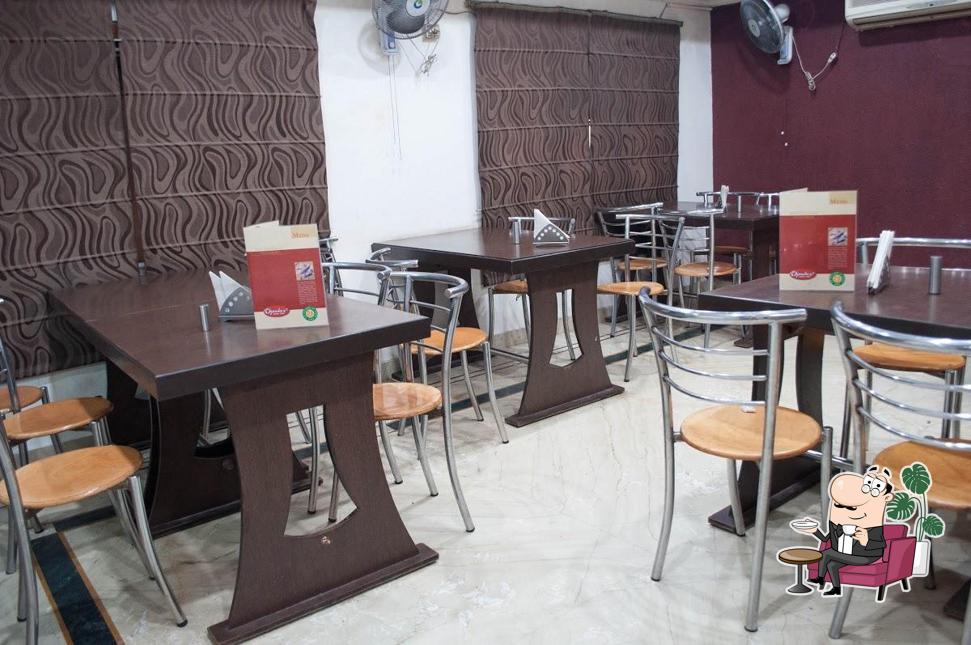 Take a seat at one of the tables at CHAWLA CHICKEN AARTI CHOWK, FEROZPUR ROAD LUDHIANA