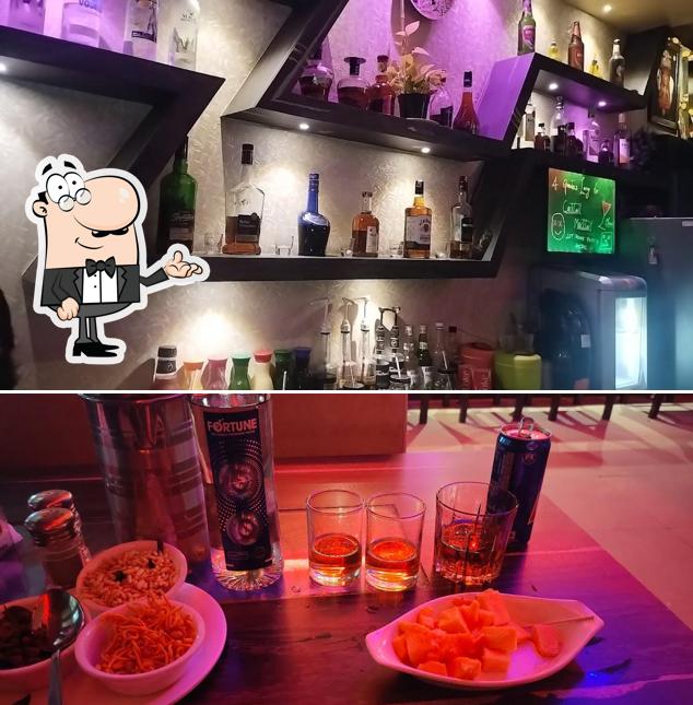 Take a seat at one of the tables at Four Quarter's Lounge Bar/Family Bar