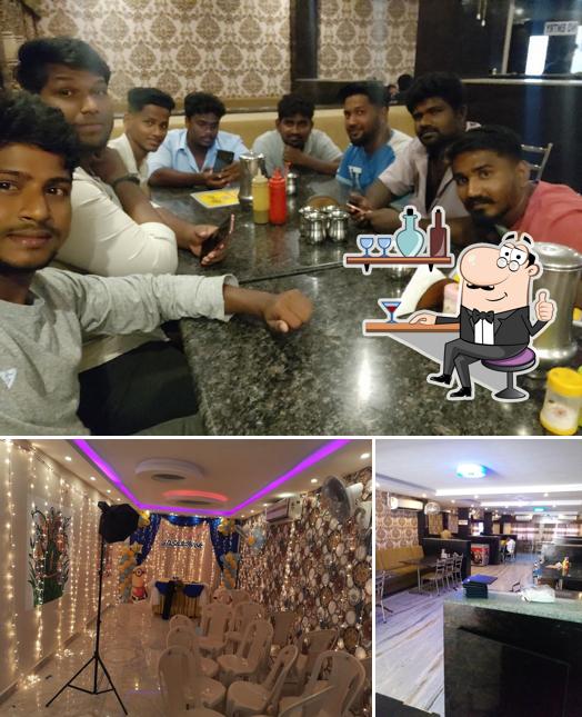 Take a seat at one of the tables at SRI RESTAURANT