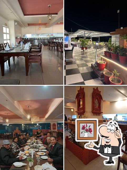 Take a seat at one of the tables at Banaras Fine Dine and Lounge