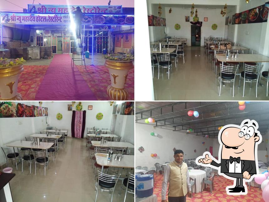 Take a seat at one of the tables at Shri New Mahadev Restaurant