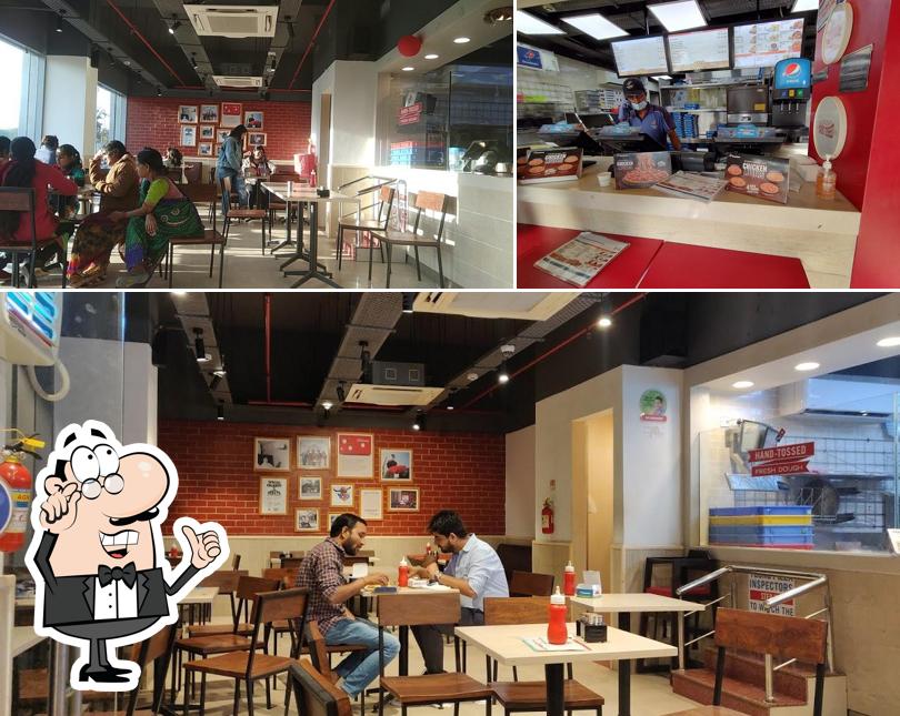 Take a seat at one of the tables at Domino's Pizza Pratap Nagar, Jaipur