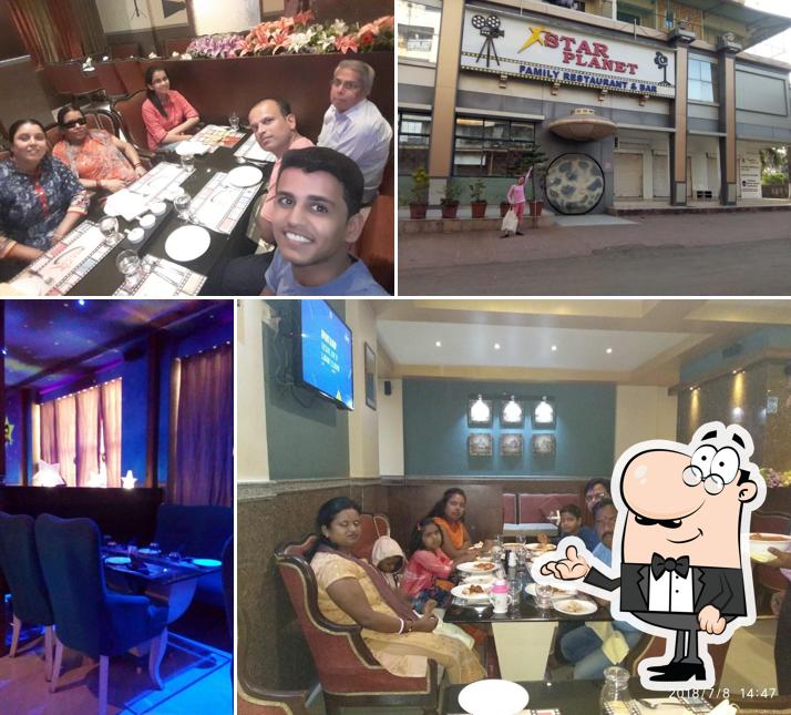 Take a seat at one of the tables at Star Planet family restaurant & bar