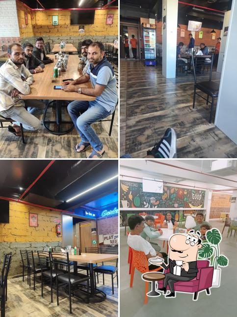 Take a seat at one of the tables at Ashirwad Hotel & Resto Cafe