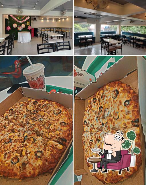 Check out the picture showing interior and food at Happynoz Pizza