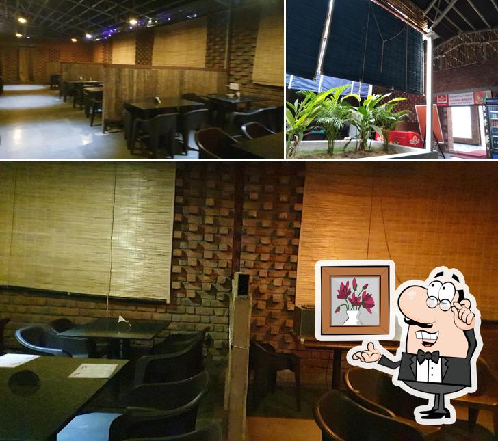 Take a seat at one of the tables at Surabhi Manair Restaurant
