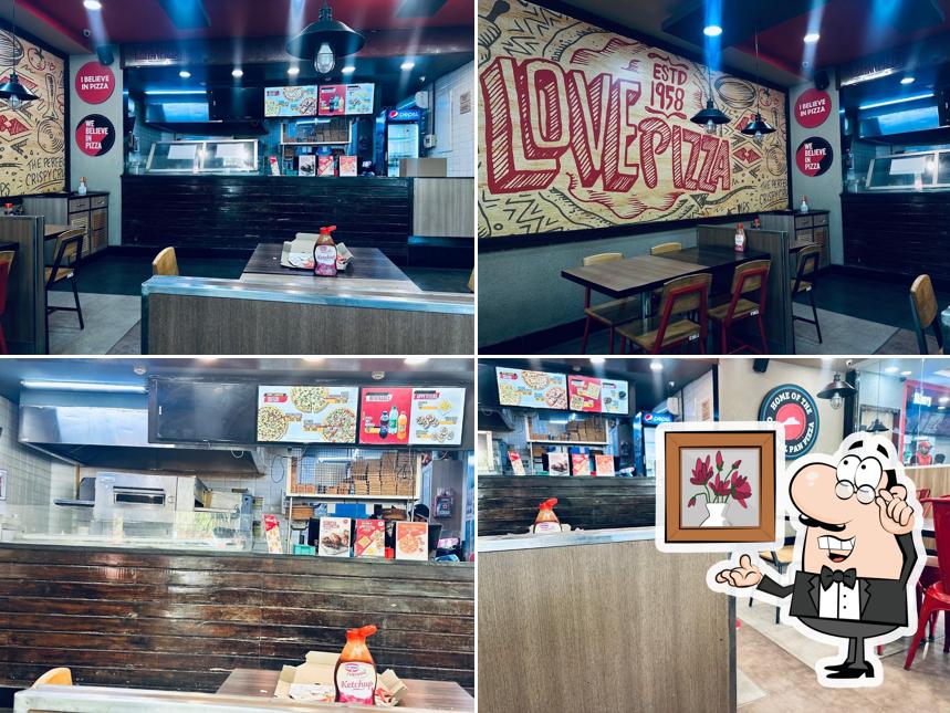 Take a seat at one of the tables at Pizza Hut JNMC Campus, Belgaum