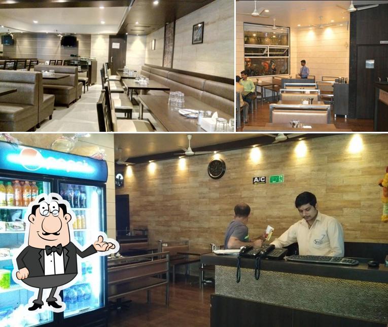 Take a seat at one of the tables at Shree Sai Hotel