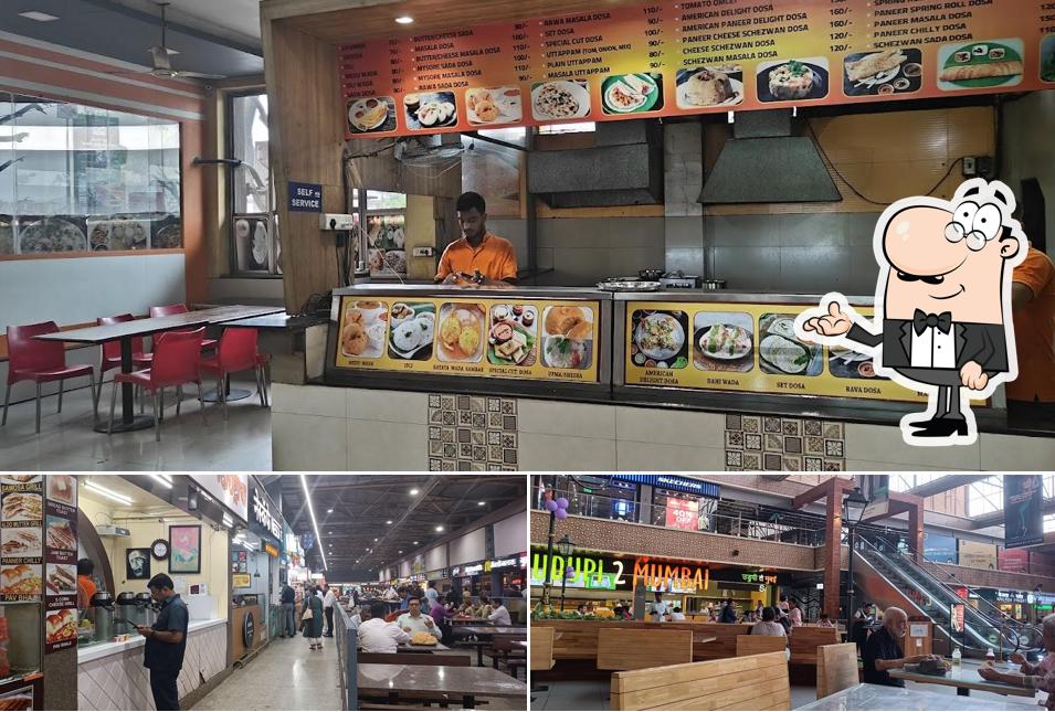 Take a seat at one of the tables at Bhairavi's Restaurant & Food court