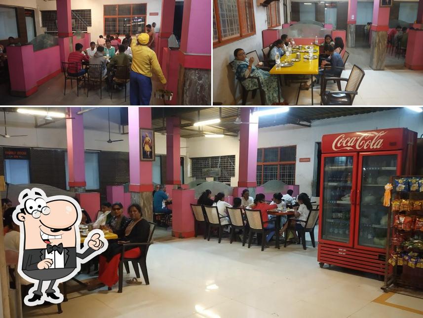 Take a seat at one of the tables at Hotel Mahesh Pure Veg