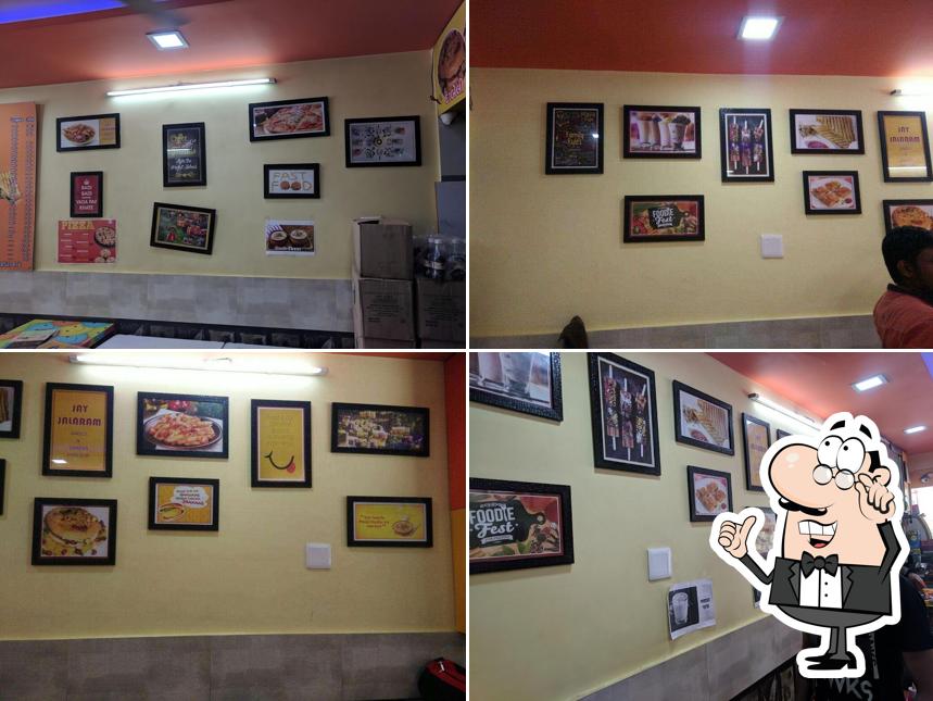 Take a seat at one of the tables at Jay Jalaram Dabeli & Snacks Parlour