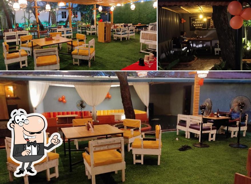 Take a seat at one of the tables at 1957 Madras Wharf Club - Restobar & Pub ECR