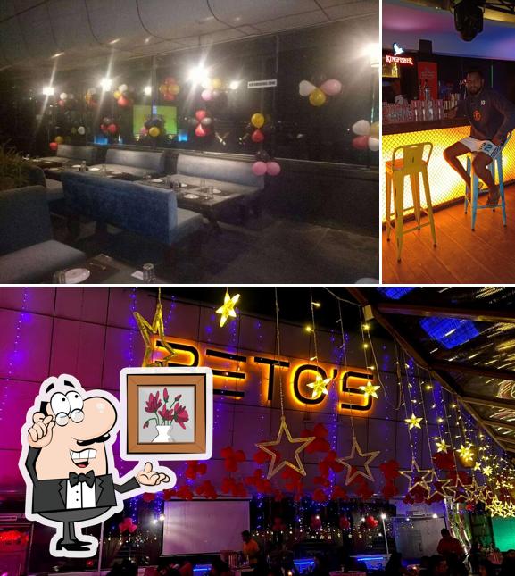 Take a seat at one of the tables at BETOS' S Bar and Kitchen