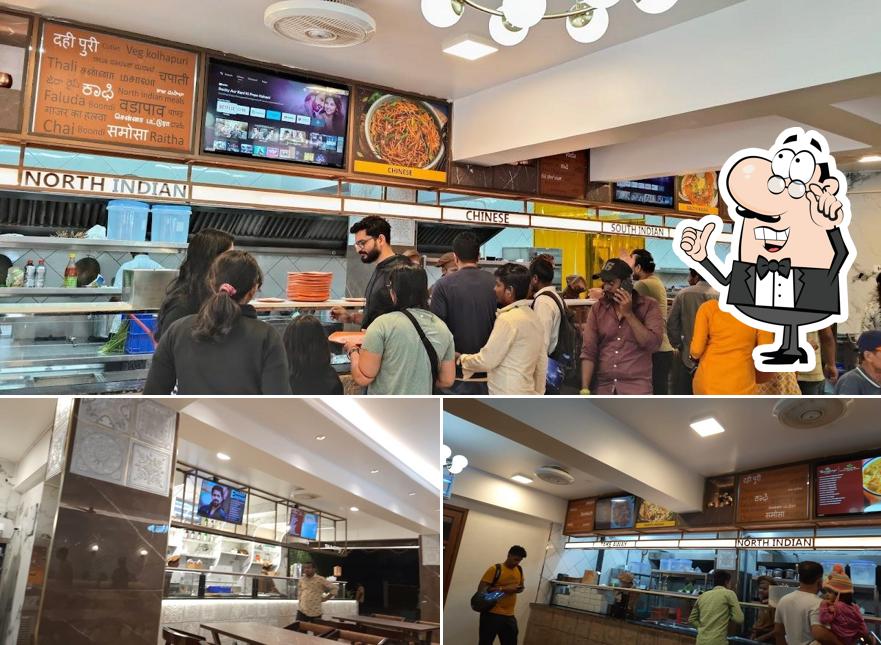 Take a seat at one of the tables at The Ramashraya Cafe