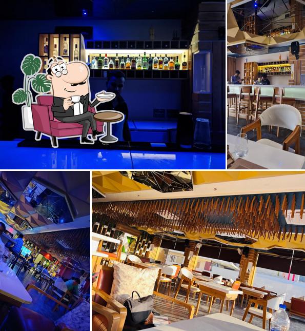 Take a seat at one of the tables at Aashiyana Bar & Family Restaurant