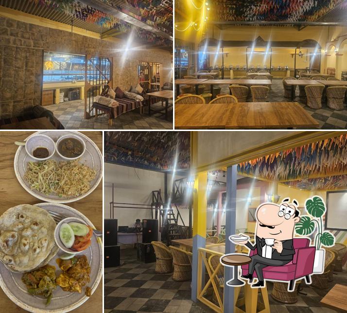 Take a seat at one of the tables at Village Restaurant - India Ka Swaad