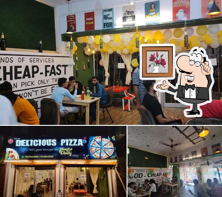 Take a seat at one of the tables at Delicious Pizza: Domito's Pizza