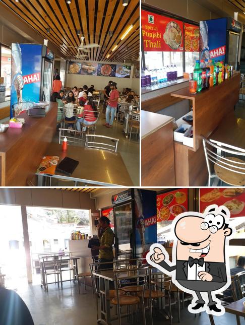 Take a seat at one of the tables at Shree ji Restaurant