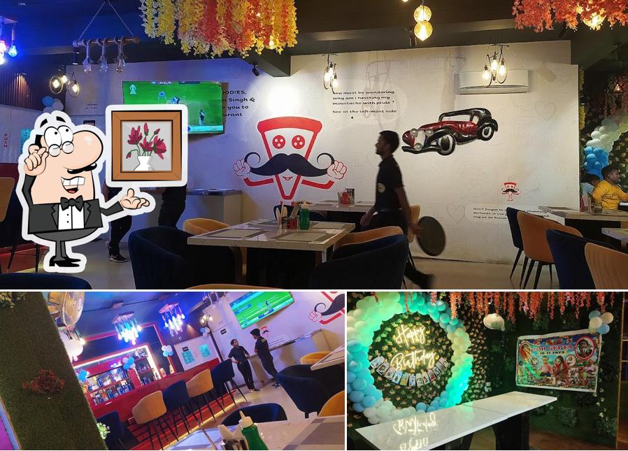 Take a seat at one of the tables at Pizza Singh Cafe & Restaurant