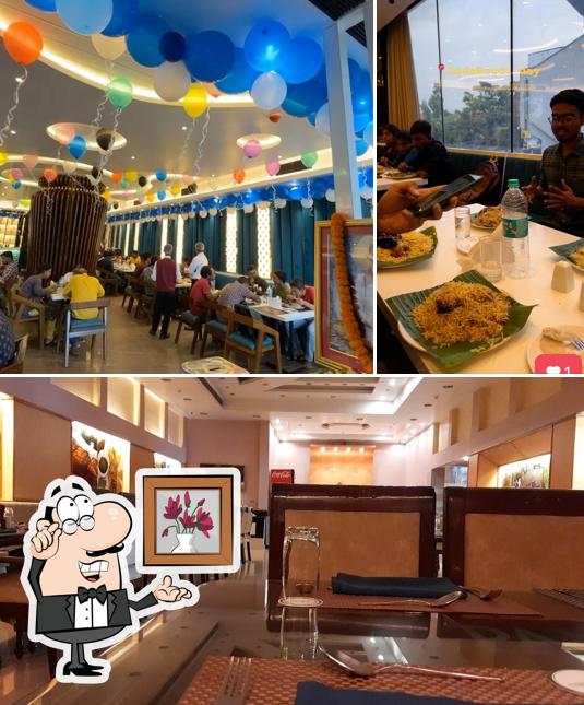 Take a seat at one of the tables at Dada Boudir Hotel Estd 1939 By Late Balai Mukherjee and Manik Mukherjee Opp Bholagiri Dharamshala