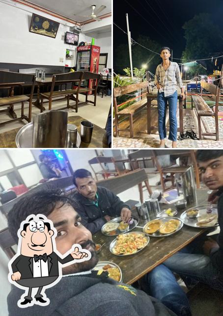 Take a seat at one of the tables at Nagmani Hotel & Restaurant