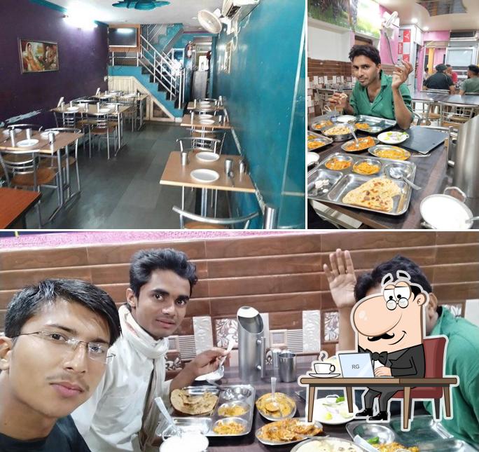 Take a seat at one of the tables at Fun And Food Restaurent