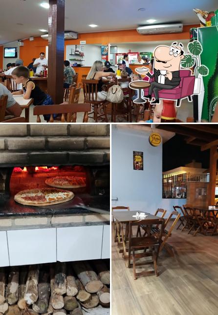 Sente em uma das mesas no Te Contei Lanches e Pizzas