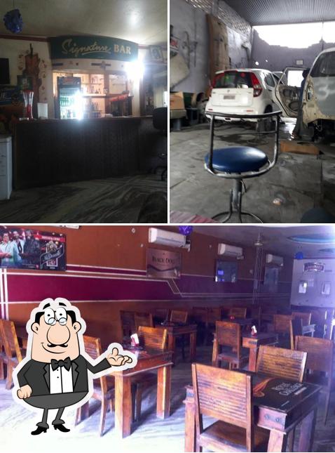 Take a seat at one of the tables at Hotel Dhruv Restaurant and Bar