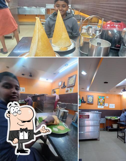 Take a seat at one of the tables at Vigneshwara Brahmins Restaurant