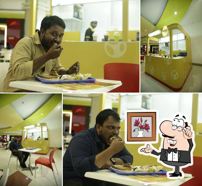 Take a seat at one of the tables at The Egg Stop - Omlette Cafe