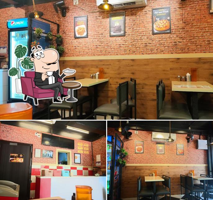 Take a seat at one of the tables at Looco's Pizza Ottapalam